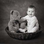 Baby in a basket with teddy
