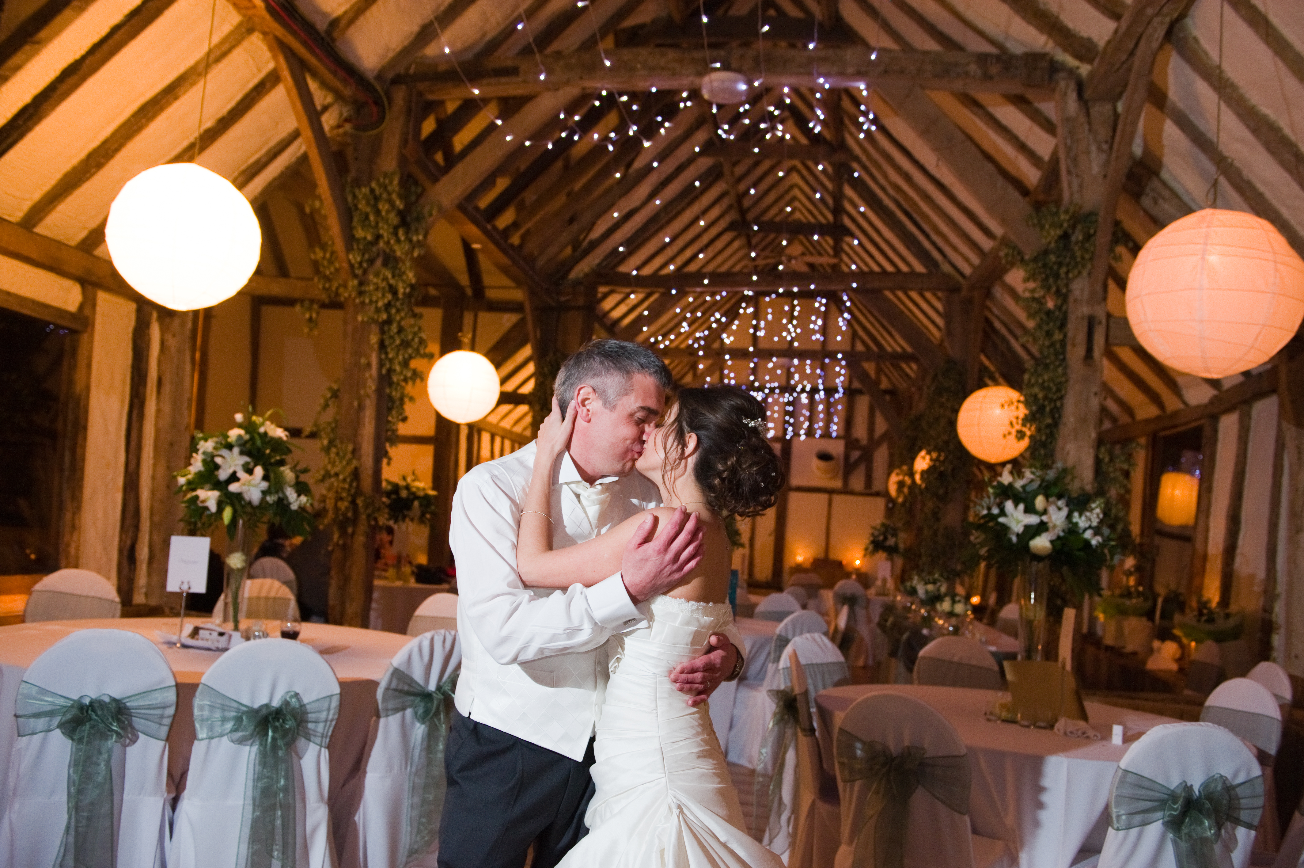 The bride and groom share a kiss at their Winters Barn wedding