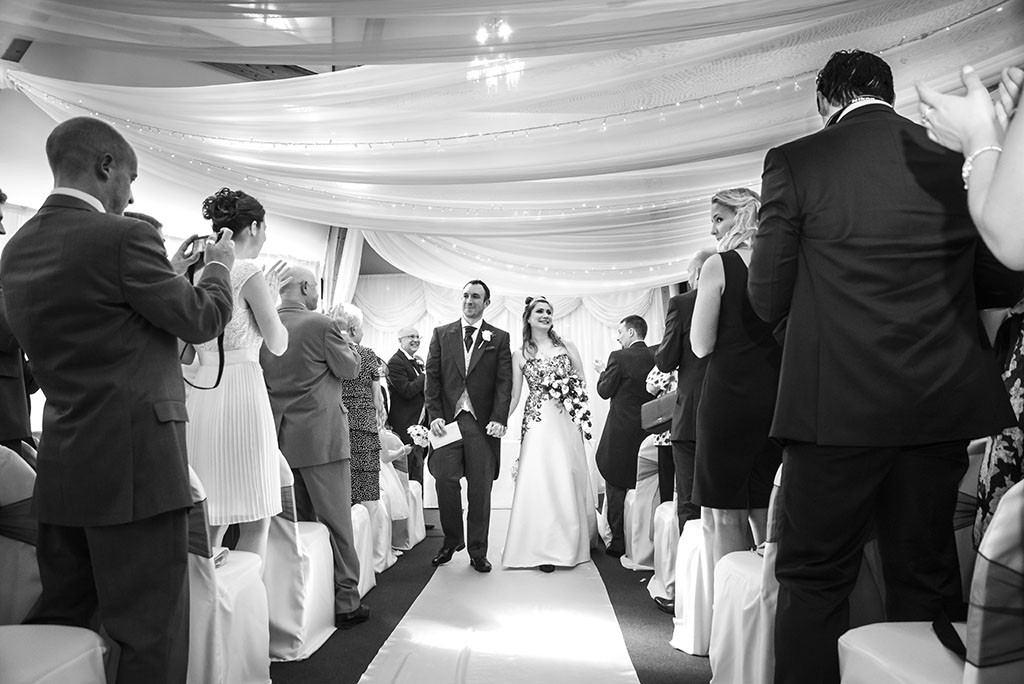 Guests taking photos with their phones at a wedding