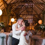 The bride and groom share a kiss at their Winters Barn wedding